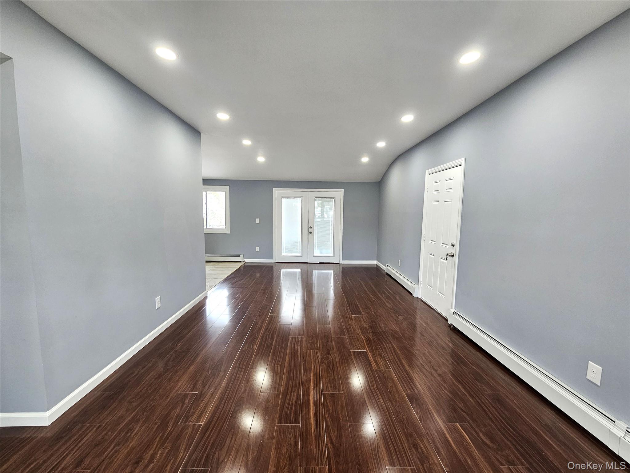 114 Granny Road Farmingville, NY 11738 - Photo 3 of 22 a view of empty room with wooden floor