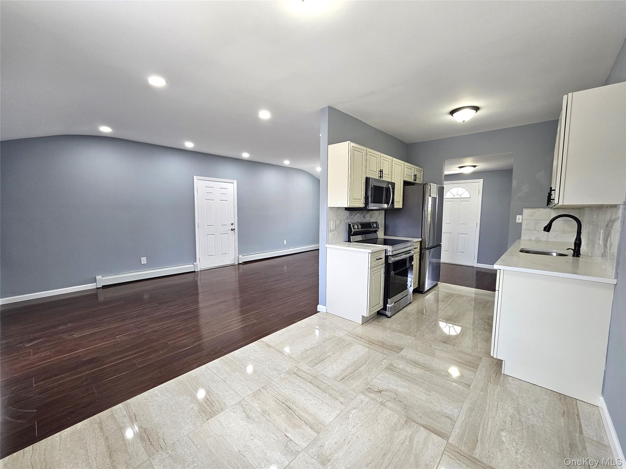 114 Granny Road Farmingville, NY 11738 - Photo 6 of 22 a kitchen with granite countertop a sink and stainless steel appliances