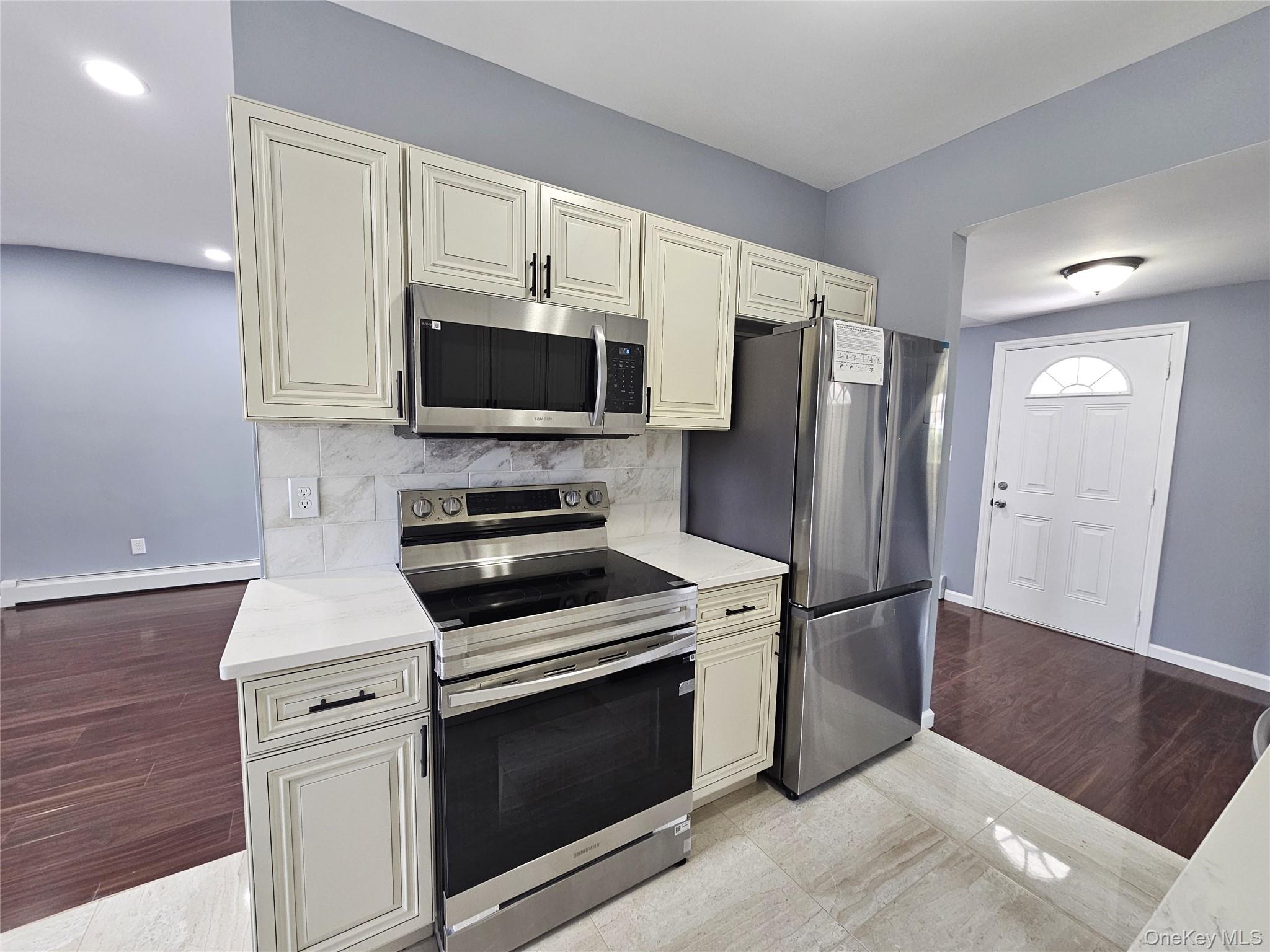 114 Granny Road Farmingville, NY 11738 - Photo 8 of 22 a kitchen with a stove microwave and refrigerator