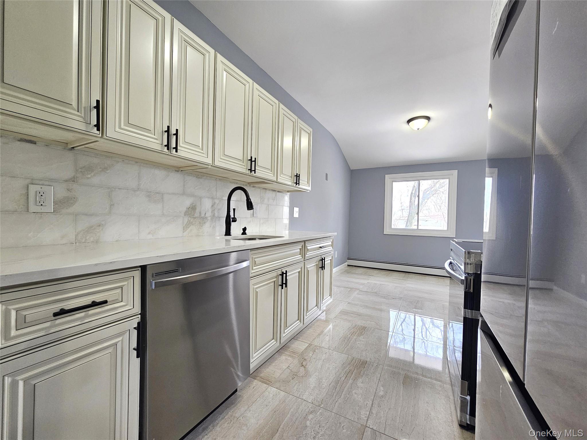 114 Granny Road Farmingville, NY 11738 - Photo 9 of 22 a kitchen with stainless steel appliances granite countertop a sink stove and cabinets
