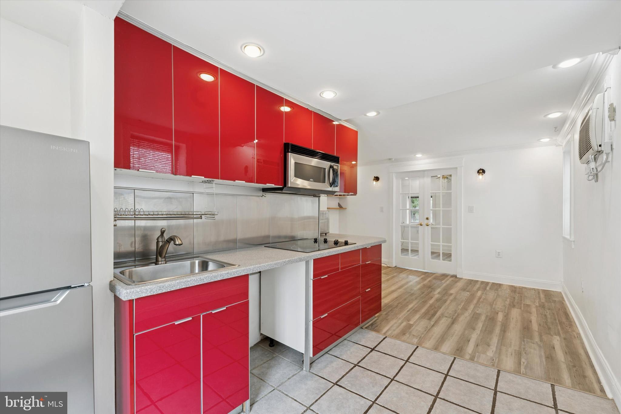 2621 Sepviva Street Philadelphia, PA 19125 - Photo 13 of 26 a kitchen with stainless steel appliances granite countertop a stove a sink and a microwave