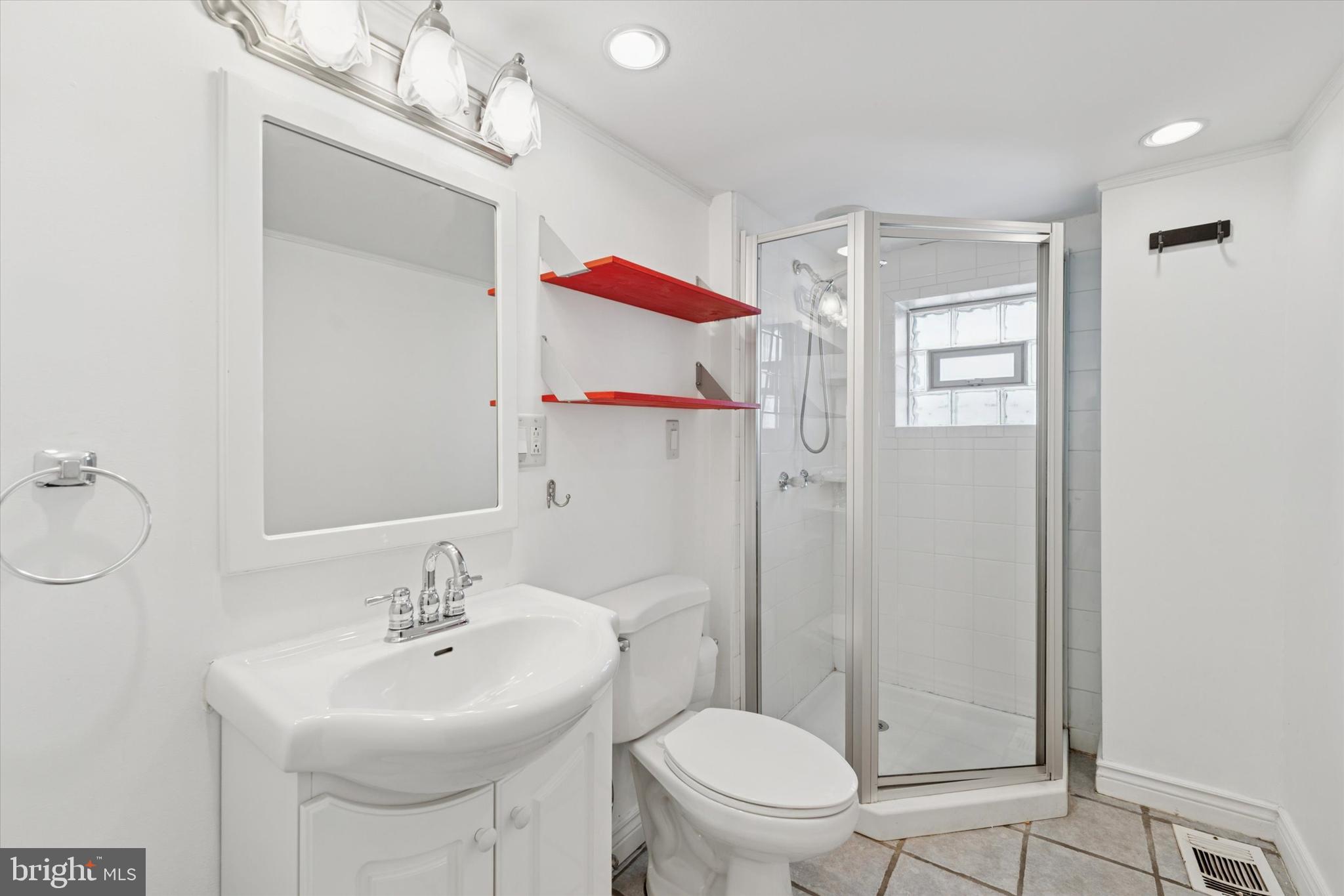 2621 Sepviva Street Philadelphia, PA 19125 - Photo 22 of 26 a bathroom with a sink toilet a mirror and shower