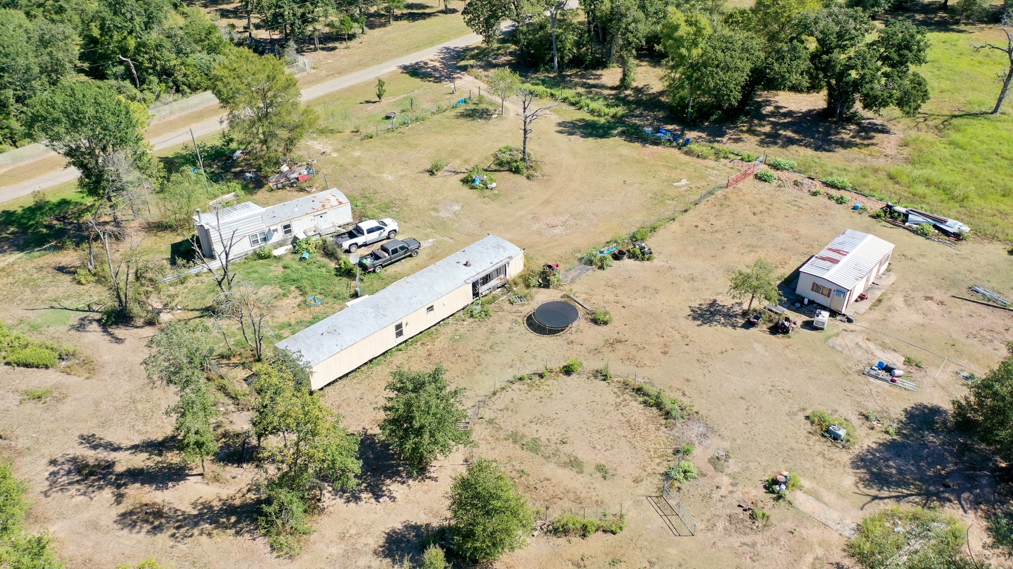 9486 Puddin Lane Madisonville, TX 77864 - Photo 13 of 16 an aerial view of a house with a yard and trees