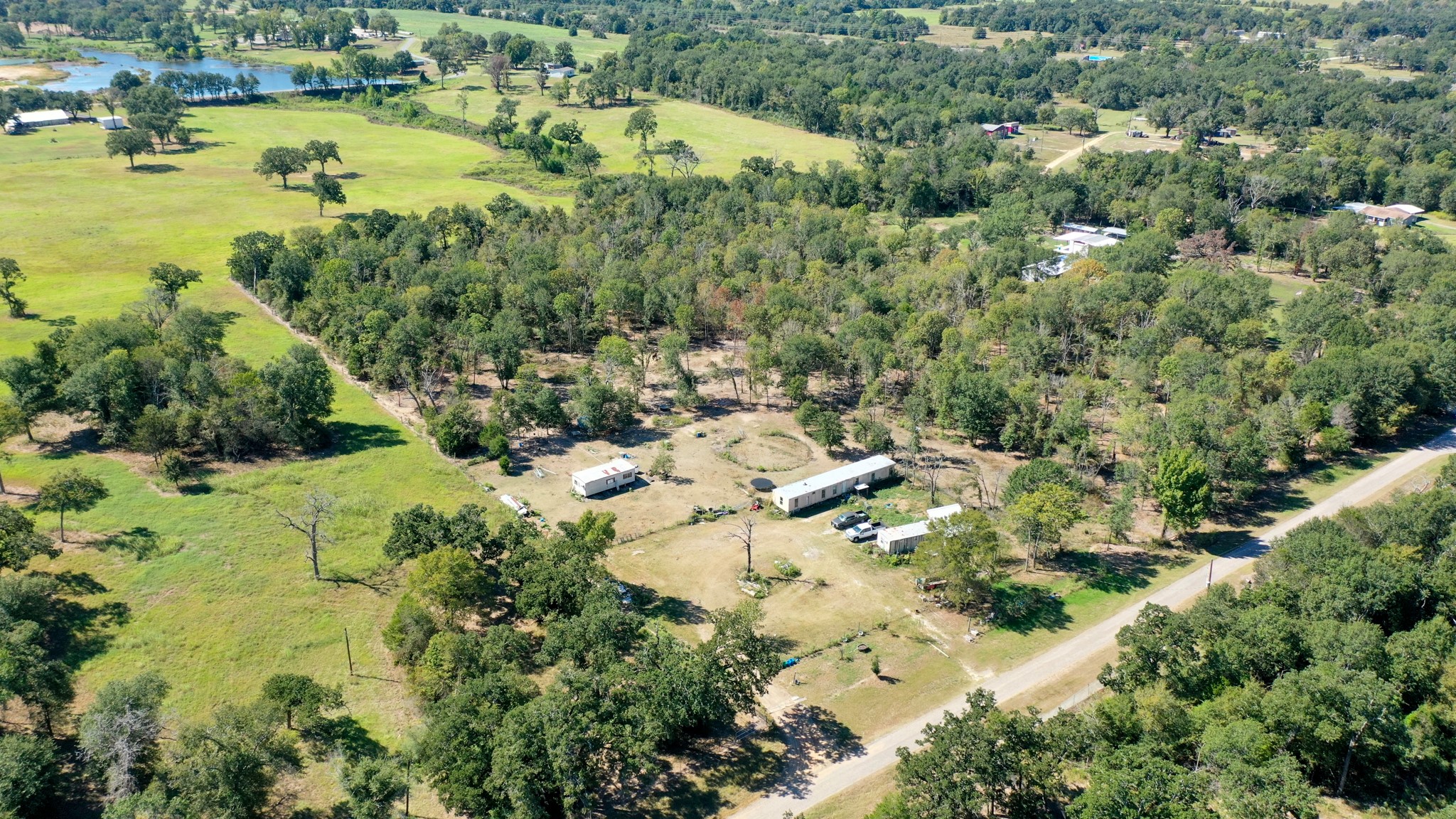 9486 Puddin Lane Madisonville, TX 77864 - Photo 2 of 16 an aerial view of residential houses with outdoor space and trees