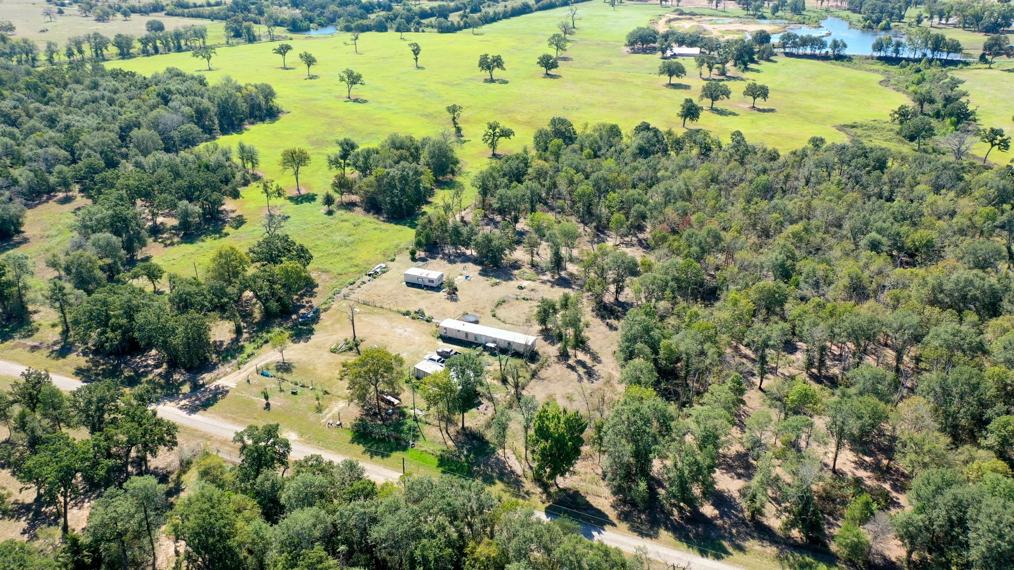 9486 Puddin Lane Madisonville, TX 77864 - Photo 3 of 16 an aerial view of residential houses with outdoor space and trees all around