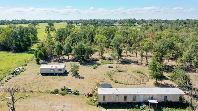 an aerial view of a house with a yard