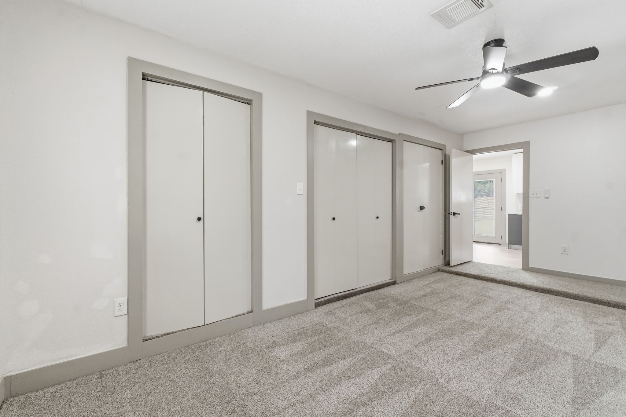 14850 Coaltown Road Willis, TX 77378 - Photo 13 of 41 Bright secondary bedroom featuring soft carpeting, neutral colors, and natural light creating a cozy atmosphere.