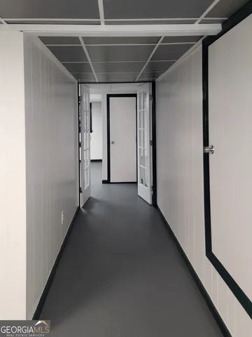 a view of a room with wooden floor