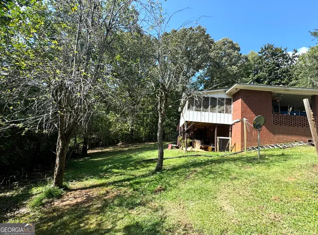 a view of a house with a yard porch and sitting area