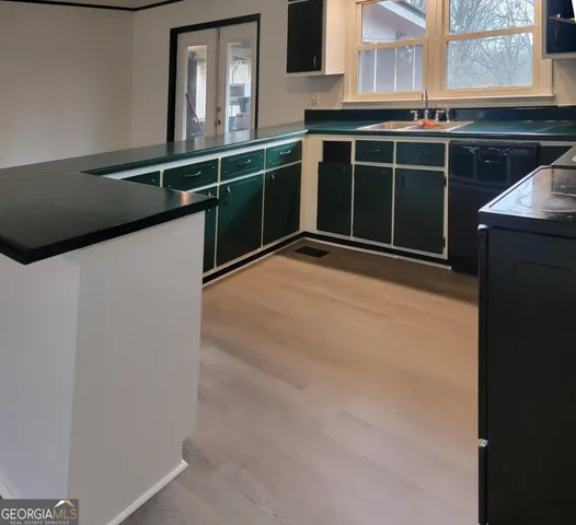 a kitchen with a sink and a refrigerator