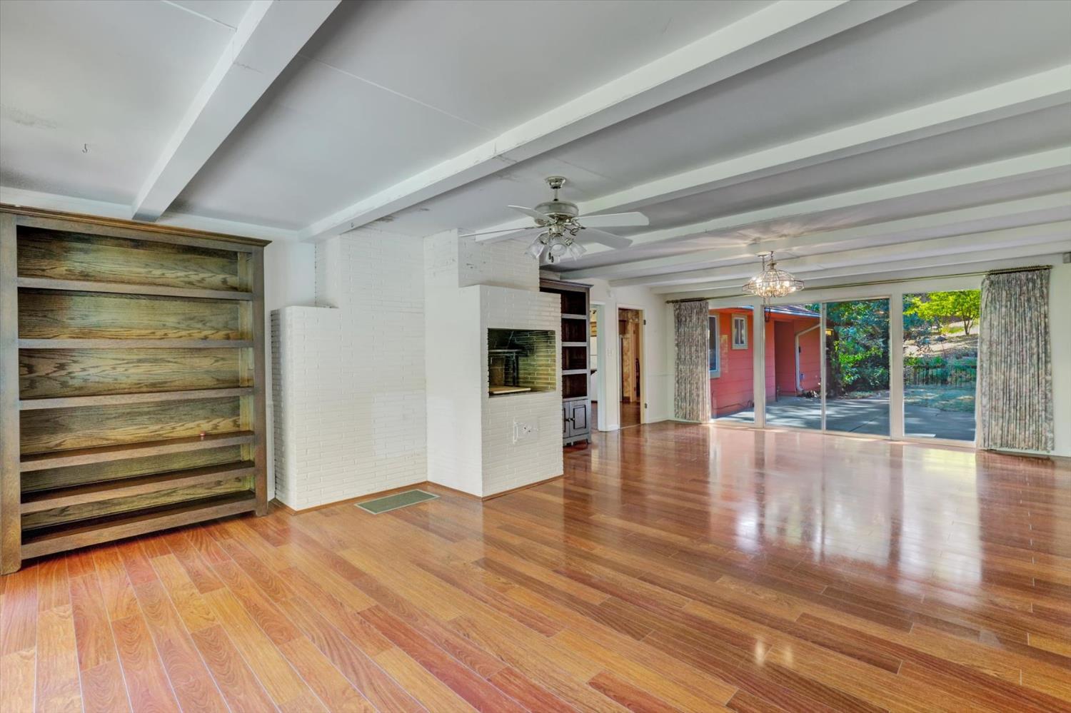 10124 South Ponderosa Way Rough and Ready, CA 95975 - Photo 13 of 63 a view of empty room with wooden floor and fan