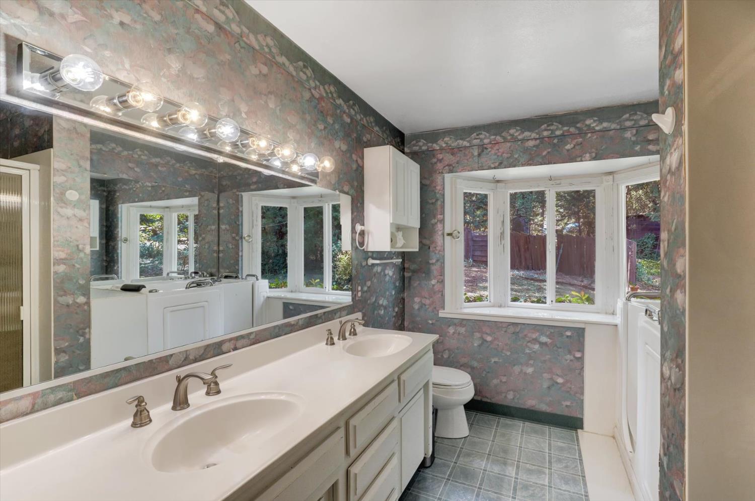 10124 South Ponderosa Way Rough and Ready, CA 95975 - Photo 19 of 63 a bathroom with a sink double vanity and a large mirror
