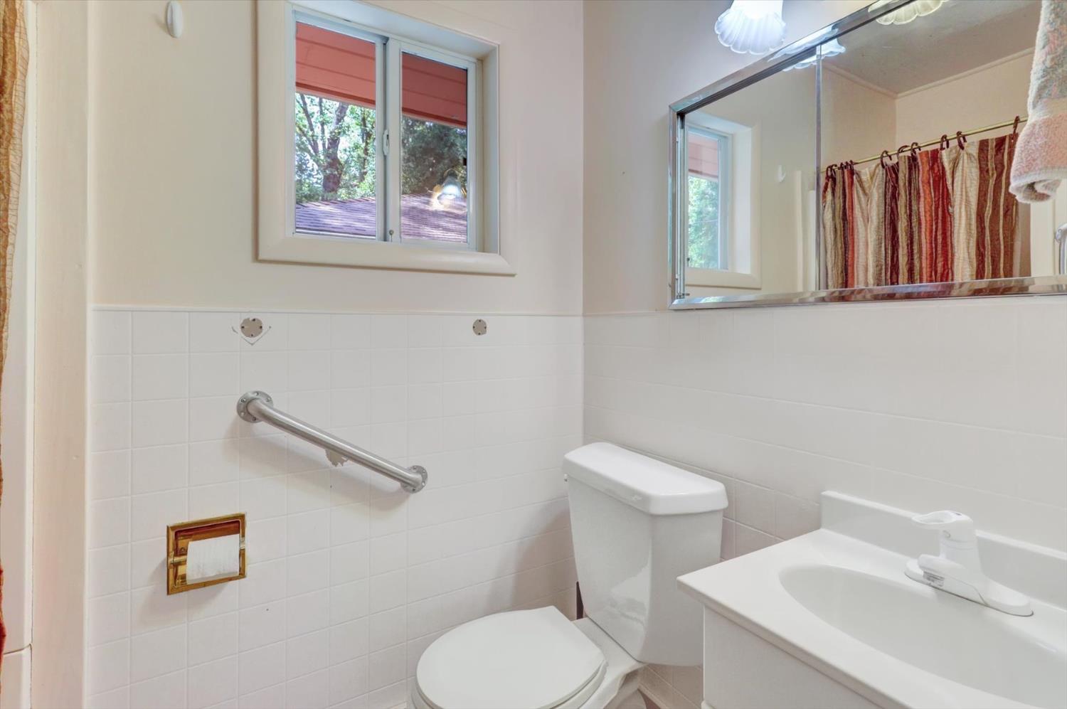 10124 South Ponderosa Way Rough and Ready, CA 95975 - Photo 27 of 63 a bathroom with a toilet a sink and a window