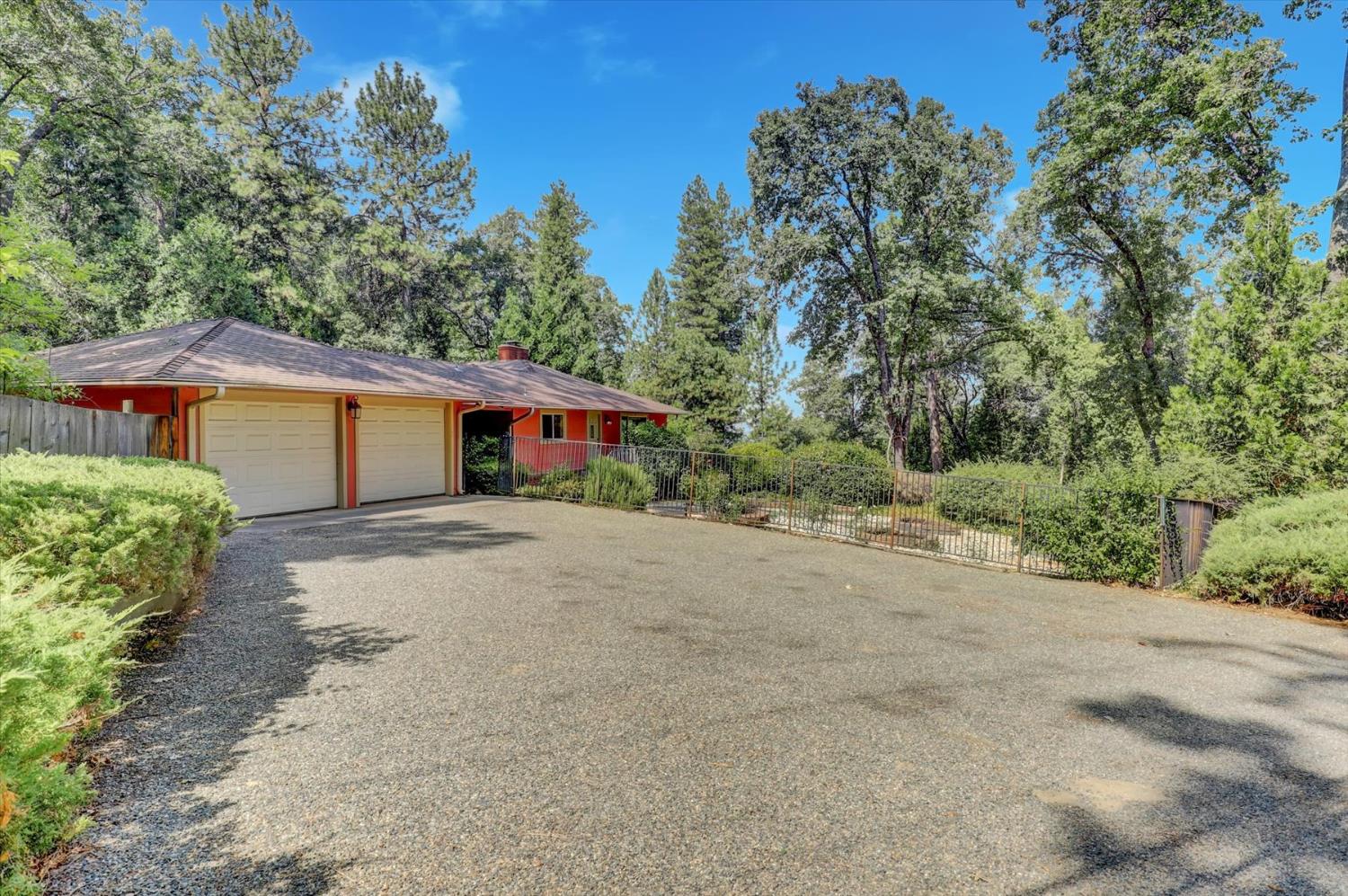 10124 South Ponderosa Way Rough and Ready, CA 95975 - Photo 28 of 63 a front view of a house with a yard and garage