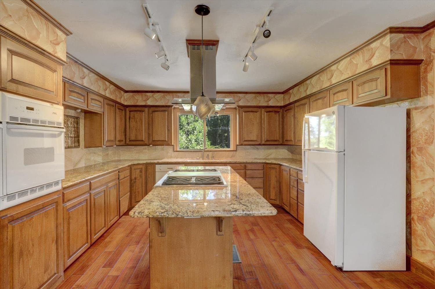 10124 South Ponderosa Way Rough and Ready, CA 95975 - Photo 3 of 63 a view of a kitchen with a sink and dishwasher with wooden floor