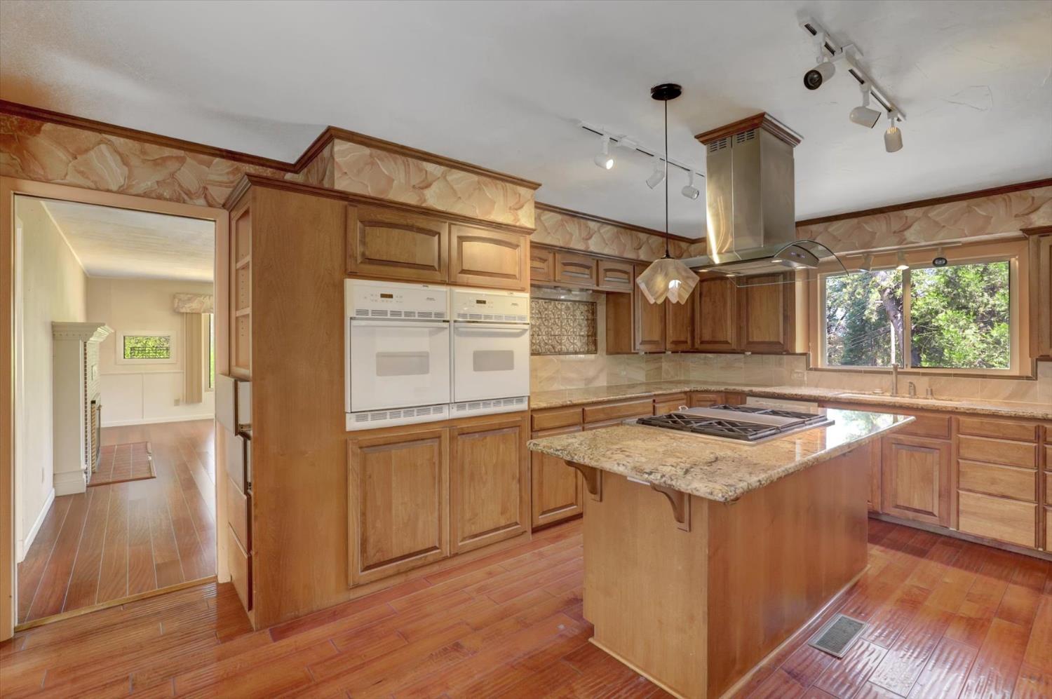 10124 South Ponderosa Way Rough and Ready, CA 95975 - Photo 4 of 63 a kitchen with stainless steel appliances granite countertop a stove and a refrigerator