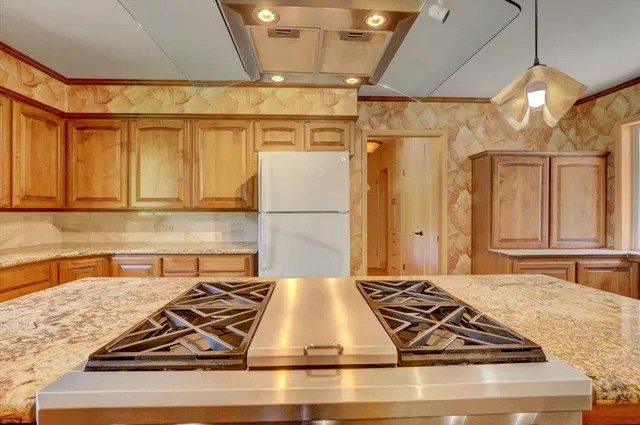 a kitchen with stainless steel appliances granite countertop a stove and a refrigerator