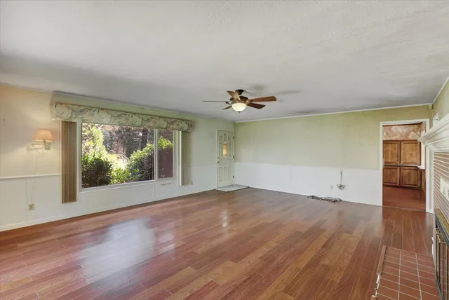 wooden floor in an empty room with a window