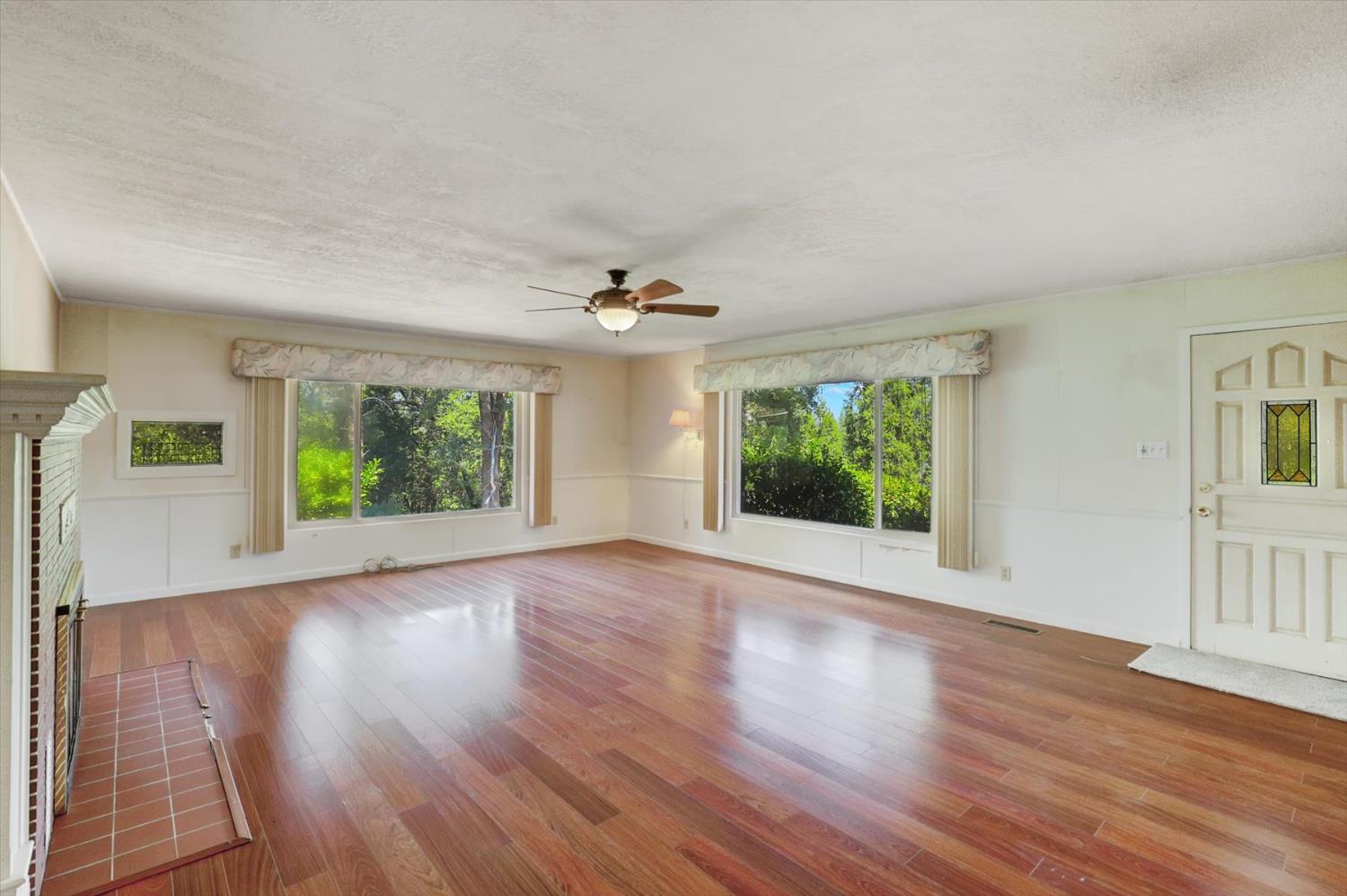 10124 South Ponderosa Way Rough and Ready, CA 95975 - Photo 9 of 63 a view of an empty room with wooden floor and a window