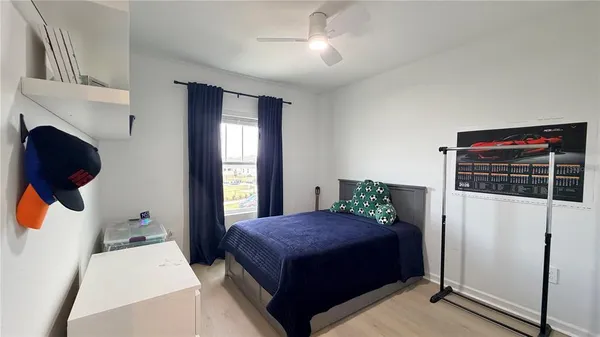 a bedroom with a bed and a television