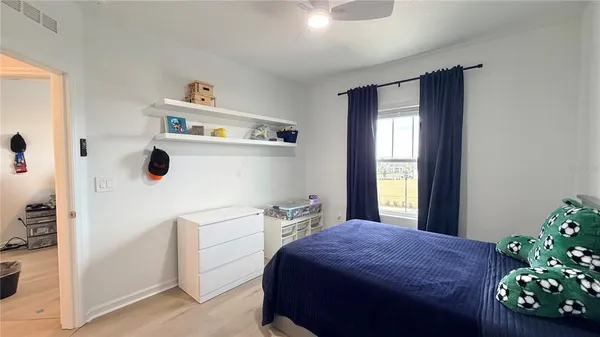a bedroom with a bed and a window