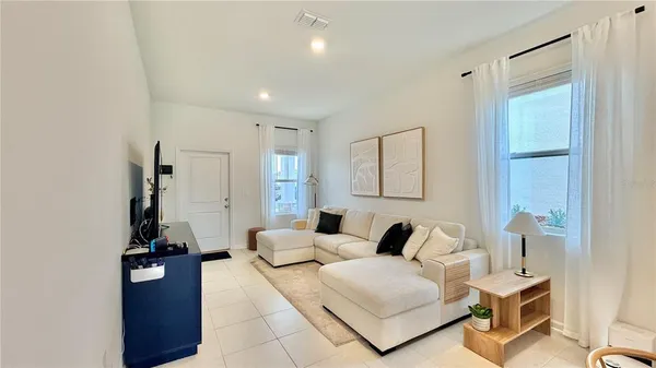 a living room with furniture and a lamp