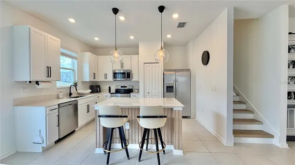a large kitchen with a table and chairs