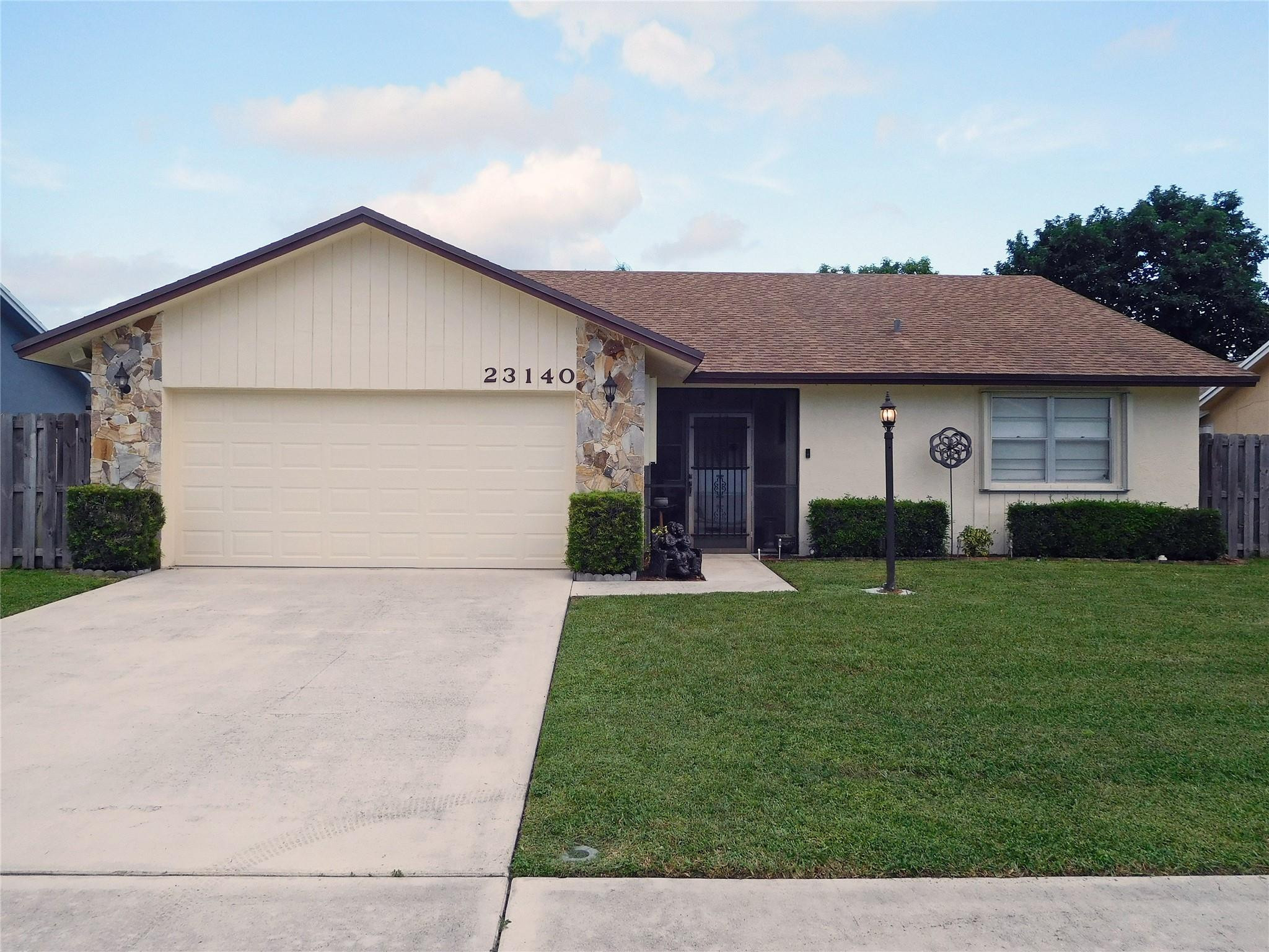23140 Southwest 55th Avenue Boca Raton, FL 33433 - Photo 1 of 39 a view of a house with a yard