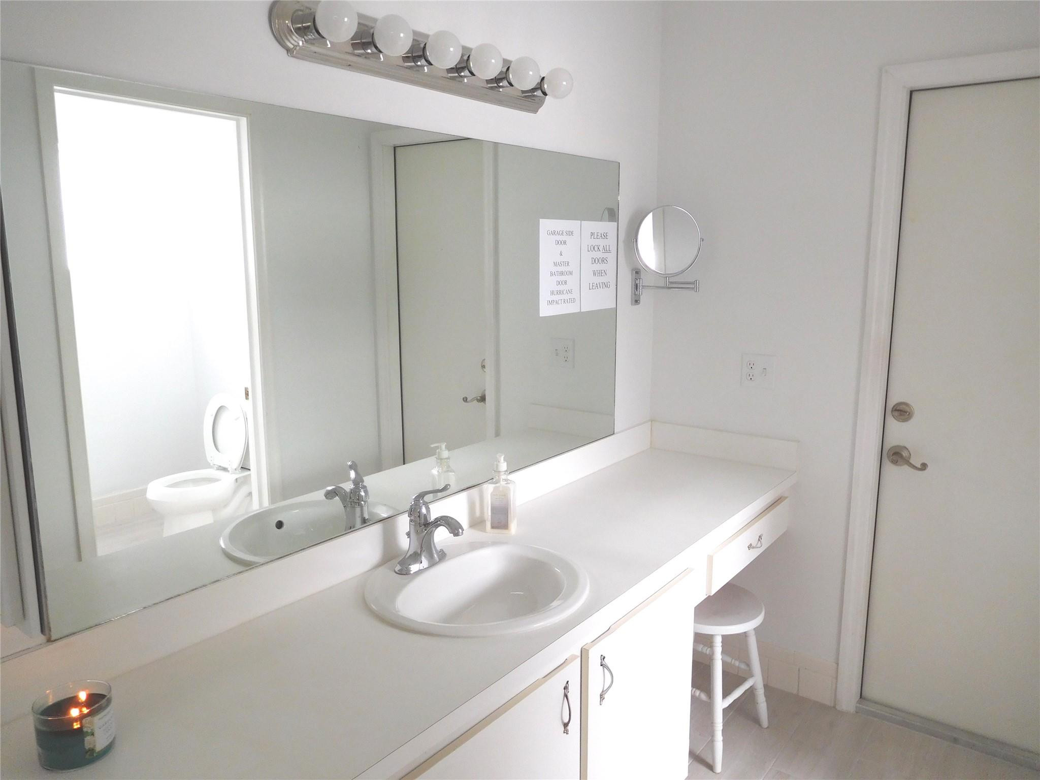 23140 Southwest 55th Avenue Boca Raton, FL 33433 - Photo 15 of 39 a bathroom with a sink vanity and a mirror