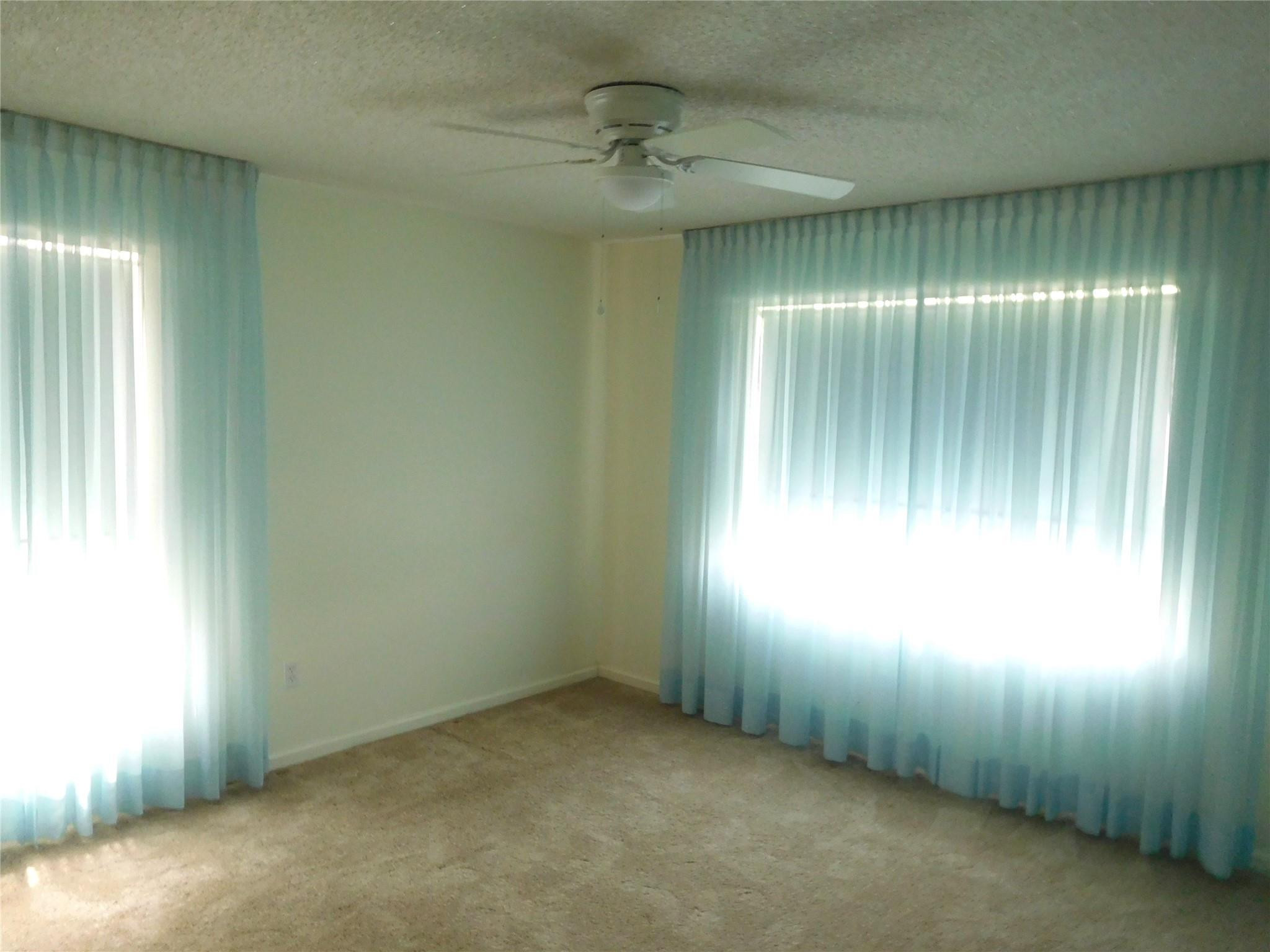 23140 Southwest 55th Avenue Boca Raton, FL 33433 - Photo 18 of 39 an empty room with windows and entrance