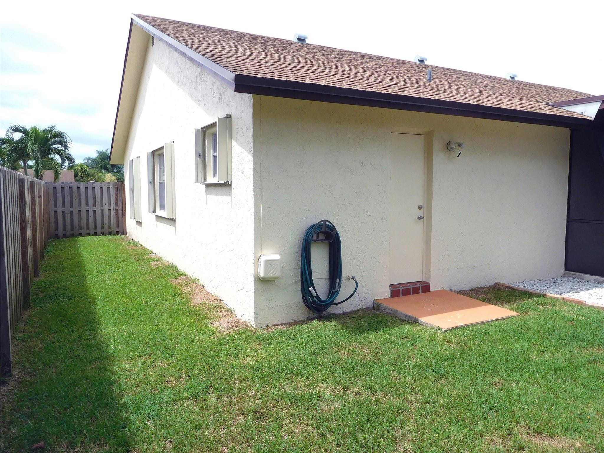 23140 Southwest 55th Avenue Boca Raton, FL 33433 - Photo 6 of 39 a front view of a house with garden