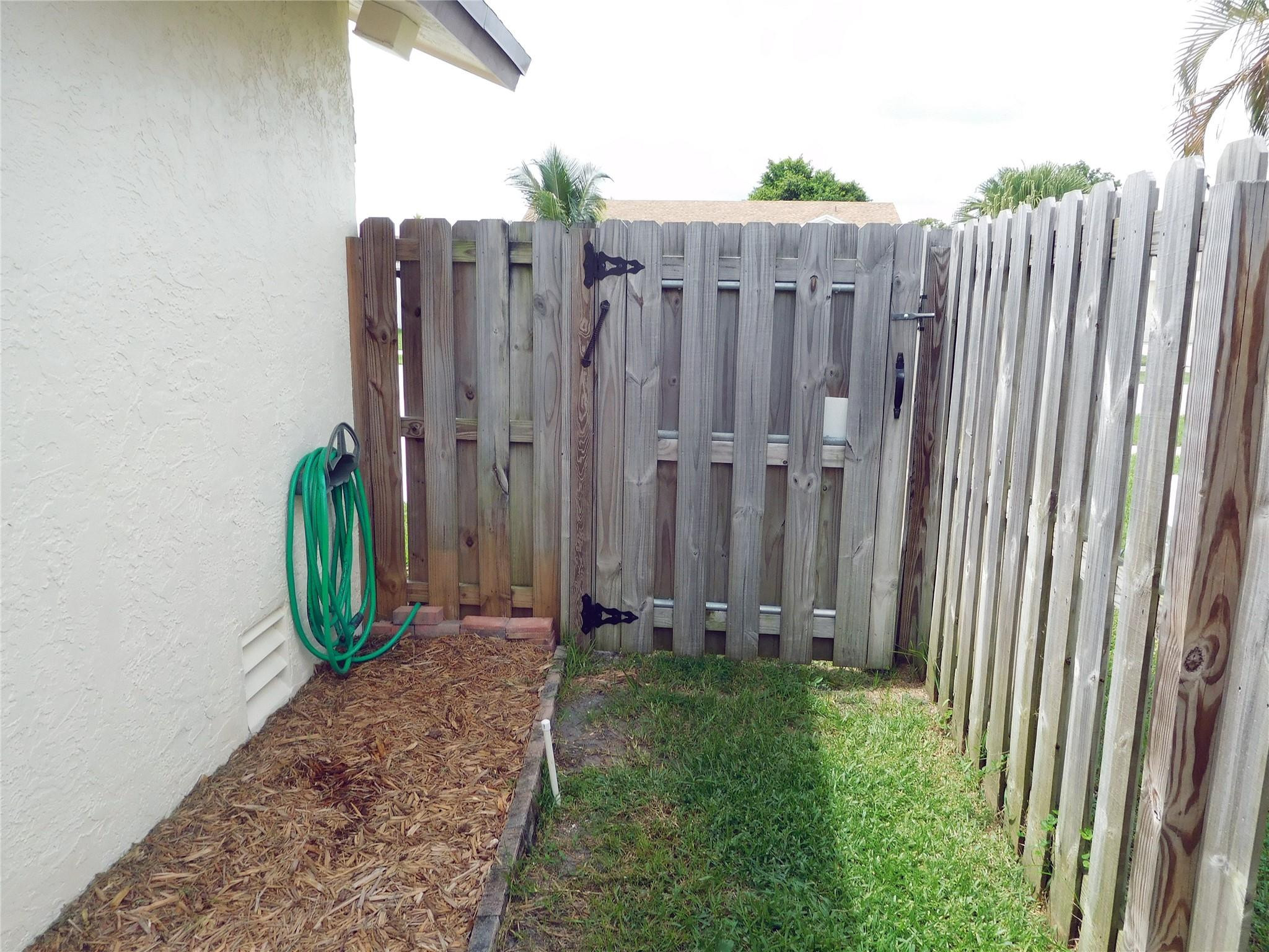 23140 Southwest 55th Avenue Boca Raton, FL 33433 - Photo 10 of 39 a view of a backyard with wooden fence