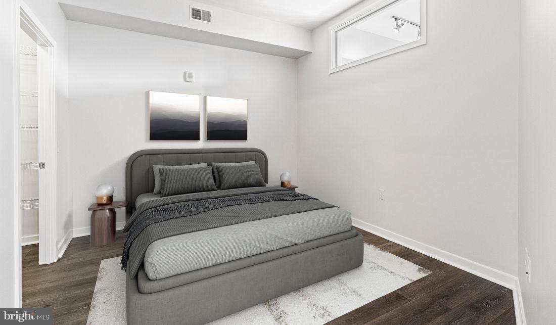 8300 Wisconsin Avenue, Unit 1B1447 Bethesda, MD 20814 - Photo 14 of 25 a bedroom with a bed and lamp