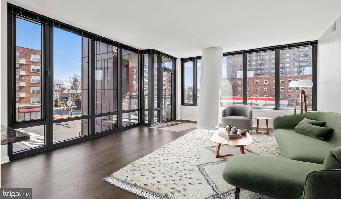 8300 Wisconsin Avenue, Unit 1B1447 Bethesda, MD 20814 - Photo 9 of 25 a living room with furniture and floor to ceiling windows
