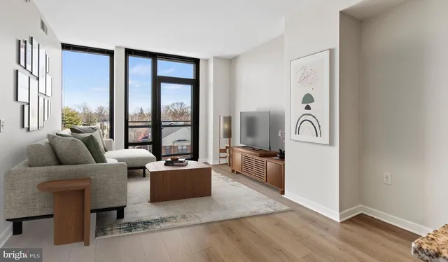 a living room with furniture and a floor to ceiling window