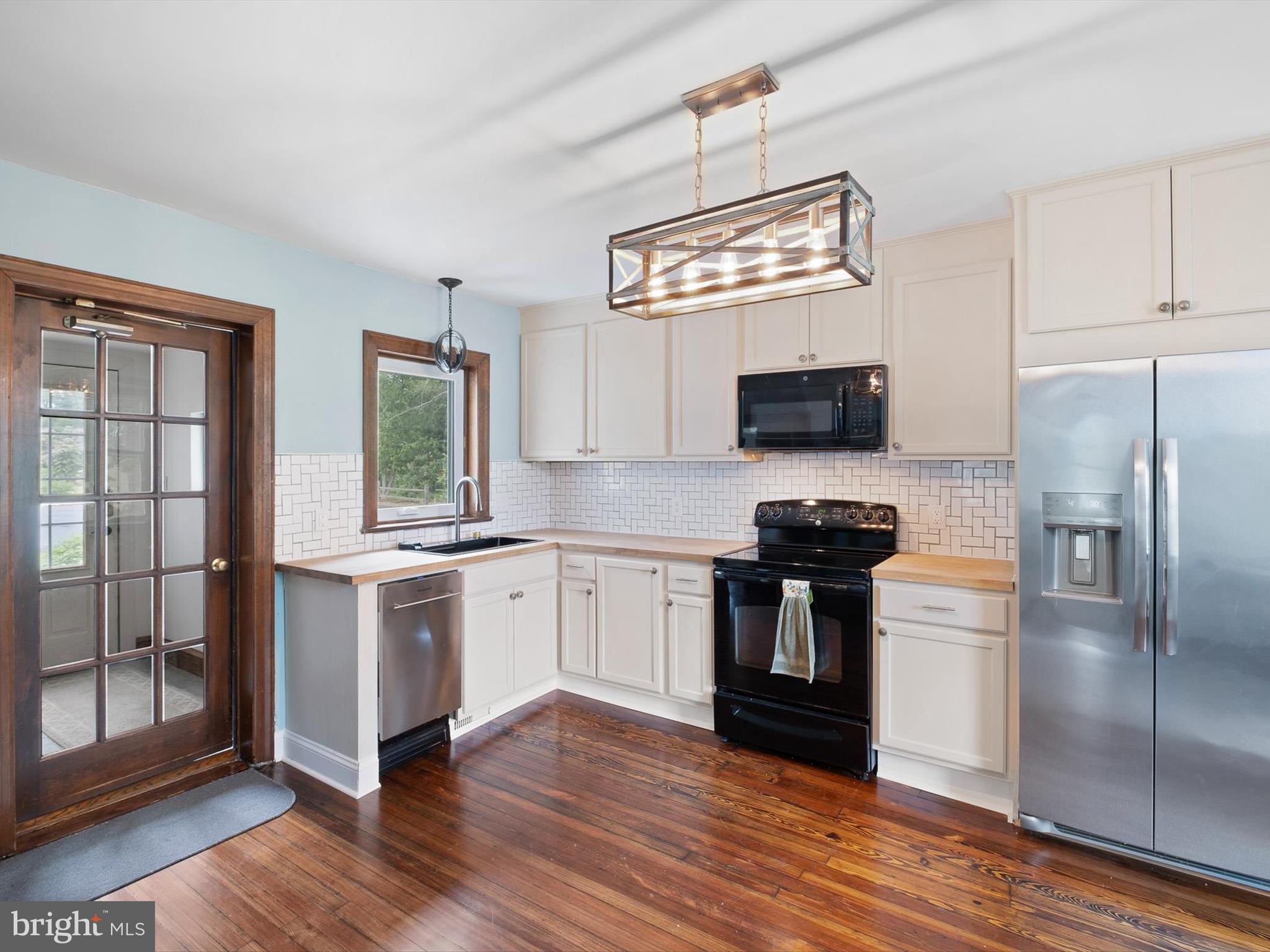 5961 Limestone Road Hockessin, DE 19707 - Photo 11 of 40 a kitchen with stainless steel appliances granite countertop a stove a sink and a refrigerator