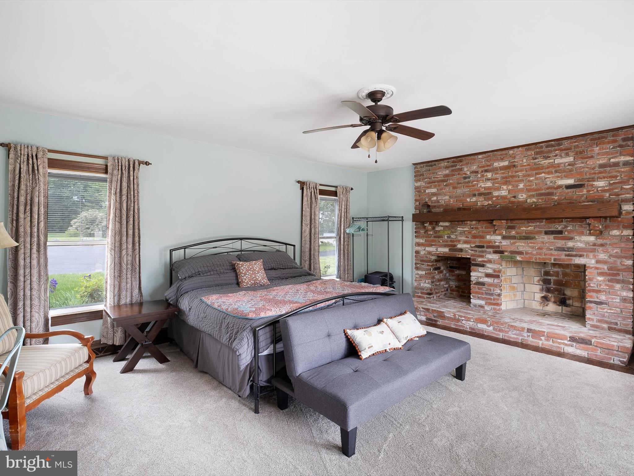 5961 Limestone Road Hockessin, DE 19707 - Photo 15 of 40 a spacious bedroom with a bed a chandelier and a large window