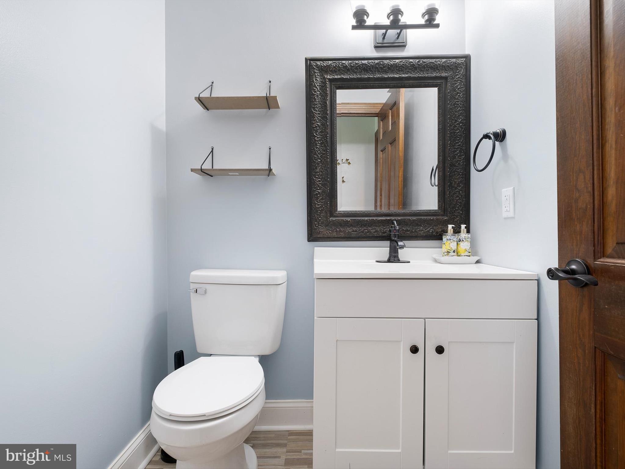 5961 Limestone Road Hockessin, DE 19707 - Photo 16 of 40 a bathroom with a toilet sink and mirror