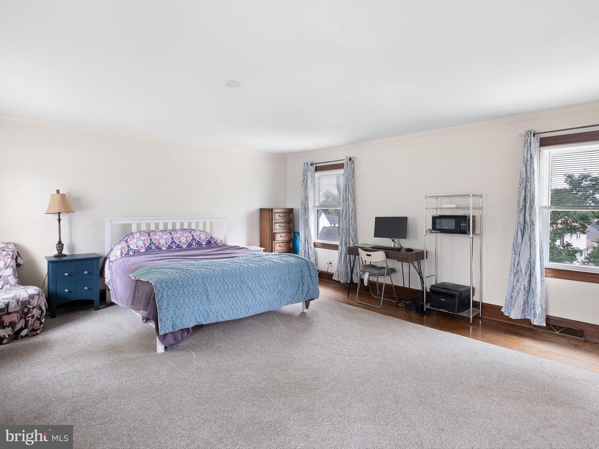 5961 Limestone Road Hockessin, DE 19707 - Photo 19 of 40 a spacious bedroom with a bed and a couch