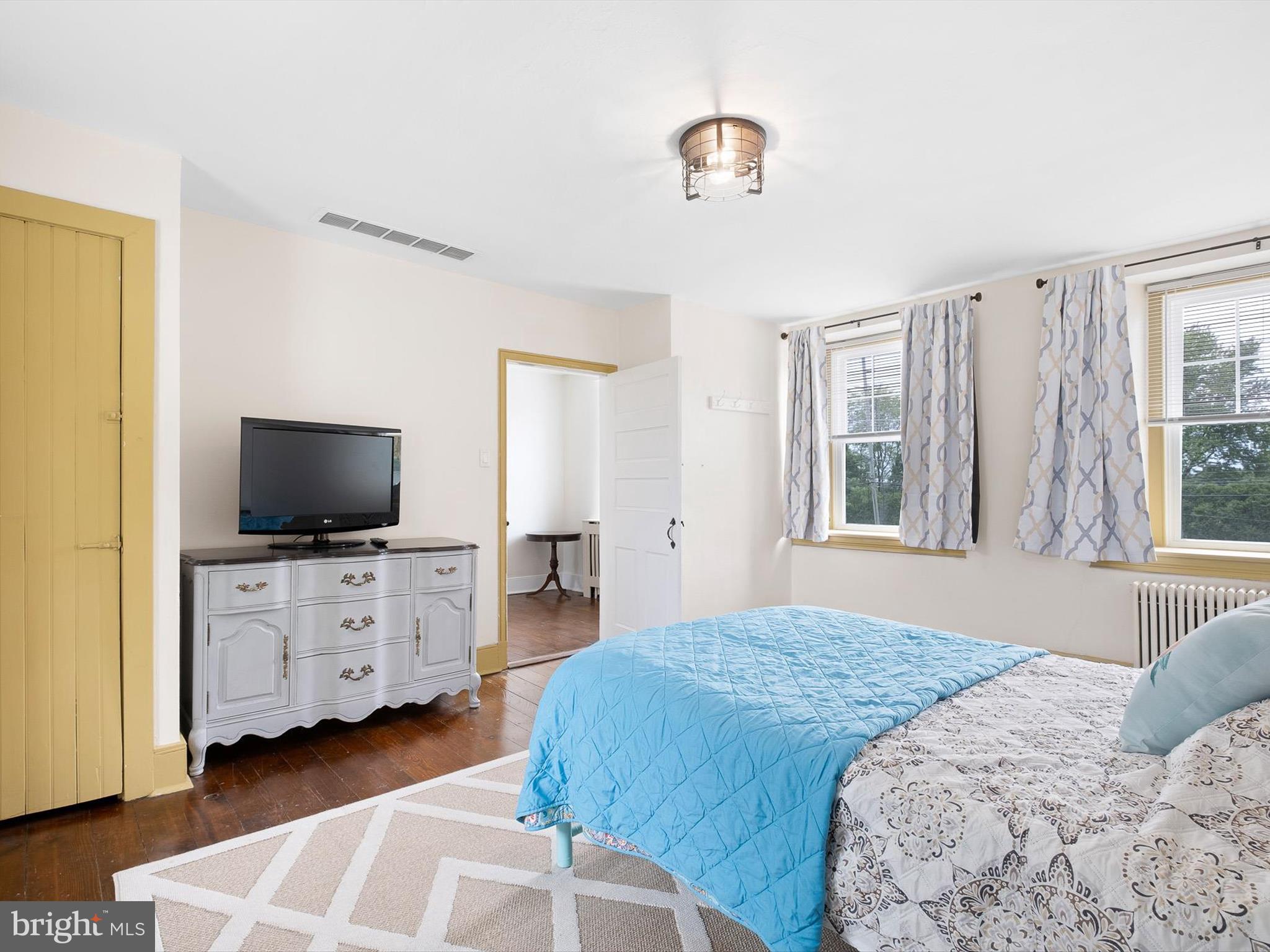 5961 Limestone Road Hockessin, DE 19707 - Photo 23 of 40 a bedroom with a bed and flat screen tv