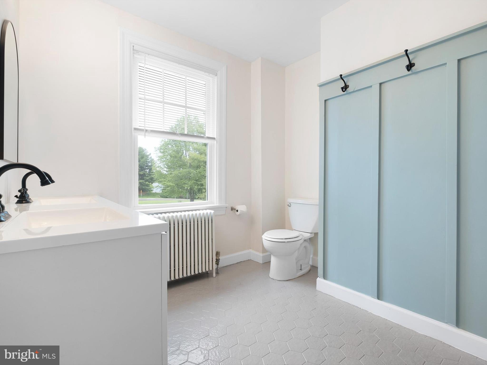 5961 Limestone Road Hockessin, DE 19707 - Photo 25 of 40 a bathroom with a toilet sink and a mirror