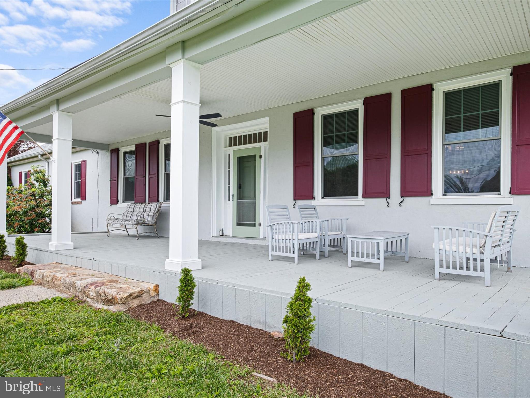5961 Limestone Road Hockessin, DE 19707 - Photo 4 of 40 front view of a house with a chairs and table in a patio