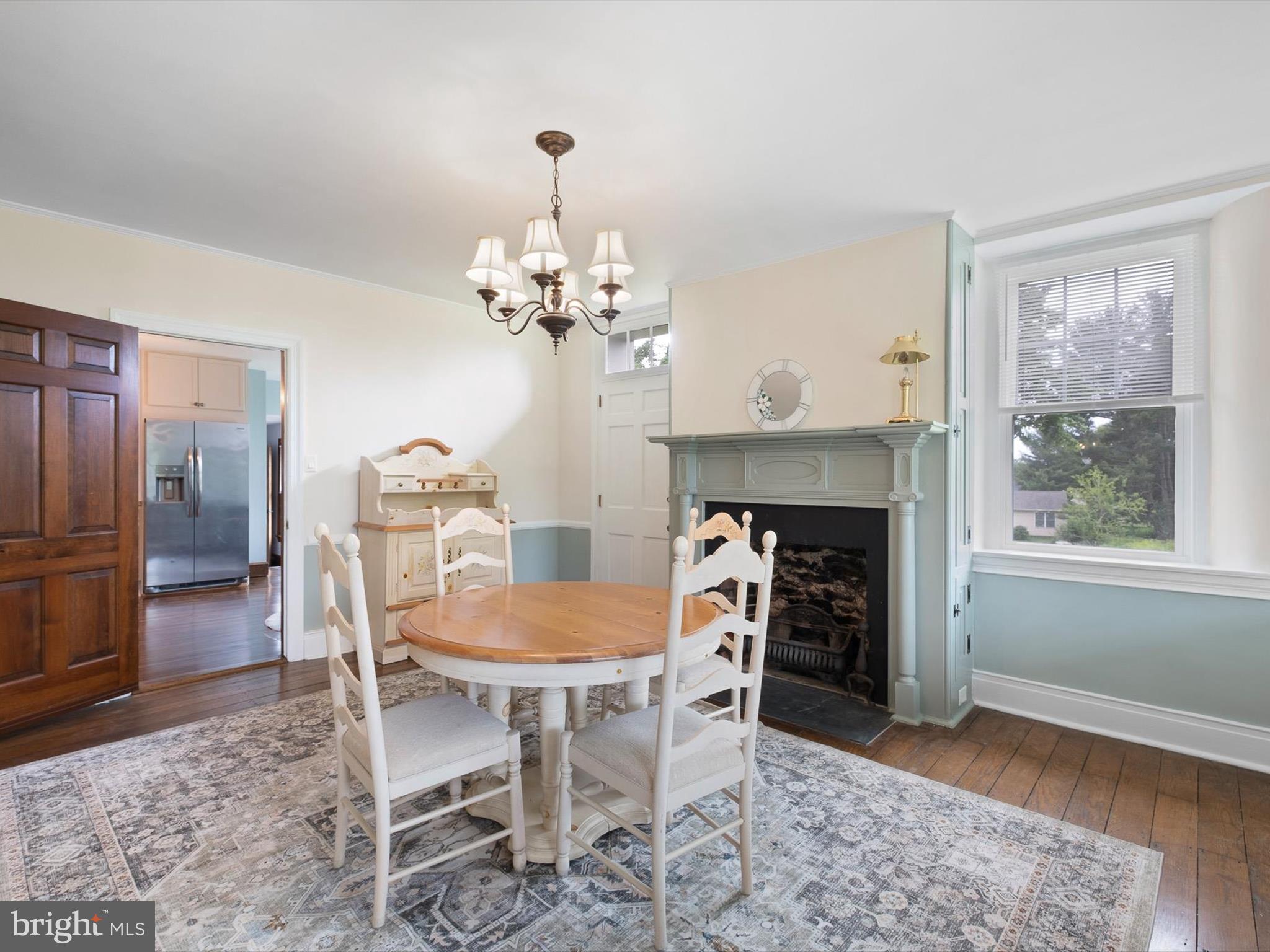5961 Limestone Road Hockessin, DE 19707 - Photo 9 of 40 a dining room with furniture a chandelier and wooden floor