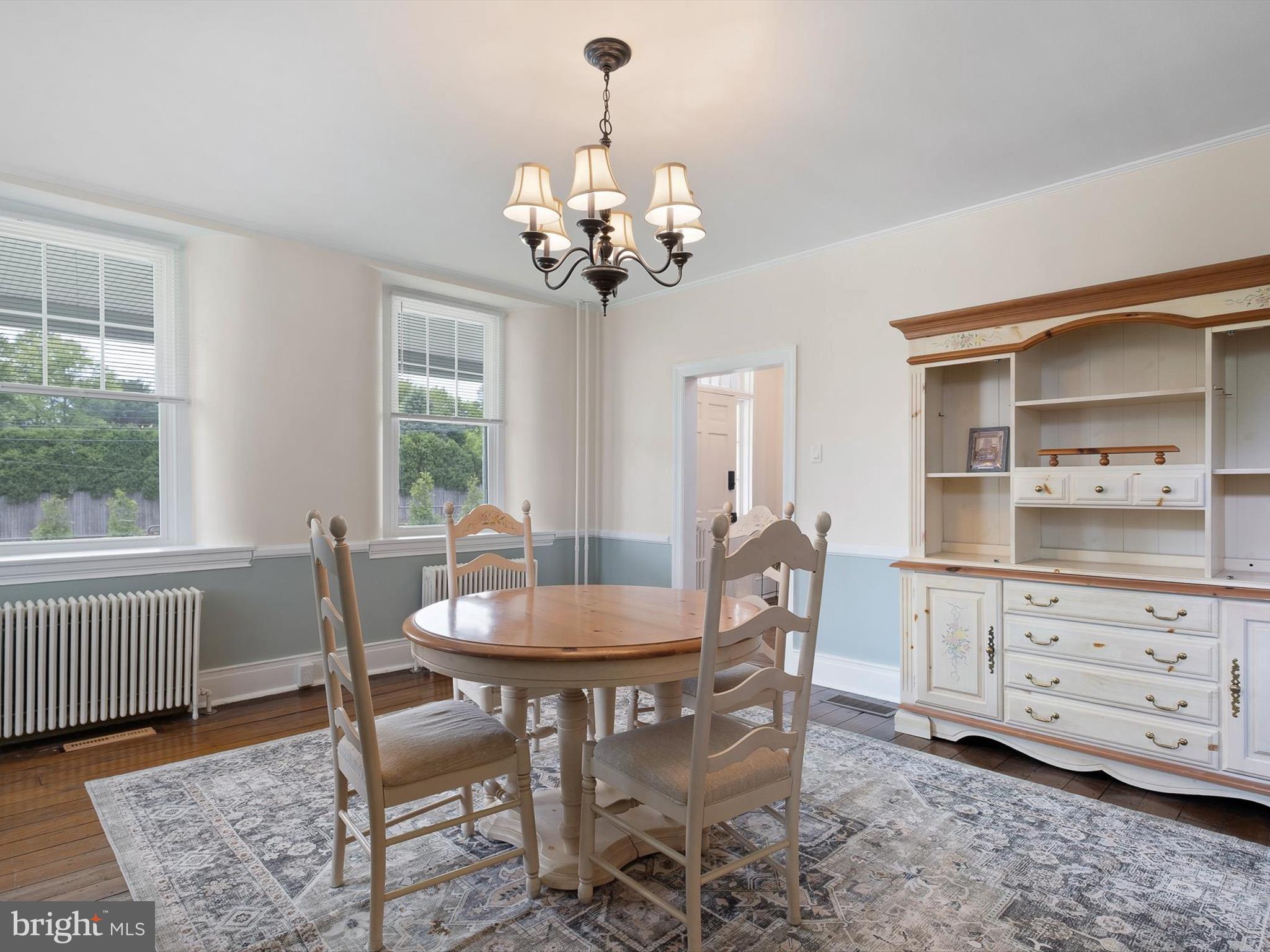 5961 Limestone Road Hockessin, DE 19707 - Photo 10 of 40 a dining room with furniture a chandelier and wooden floor