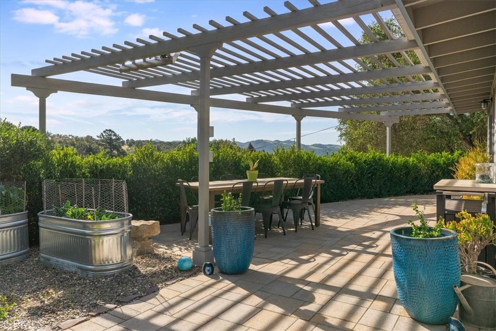 571 Corralitos Road Arroyo Grande, CA 93420 - Photo 11 of 54 Front of house with dining area, overhead heater and raised flower beds