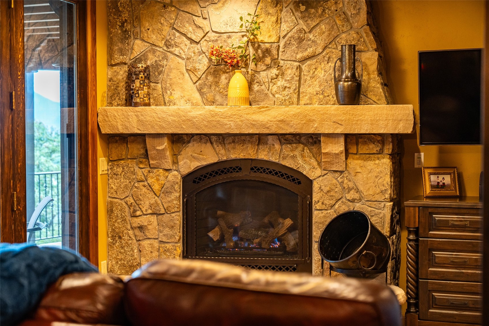 31 Pinnacle Lane Dillon, CO 80435 - Photo 32 of 50 a living room with a fireplace and a wooden floor