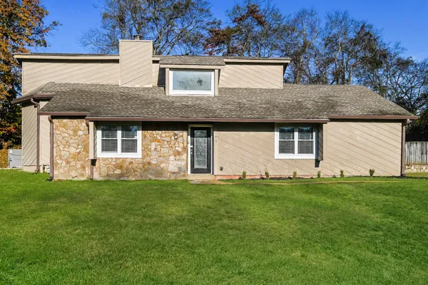 a front view of a house with a garden