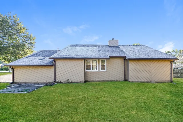 a front view of house with a garden