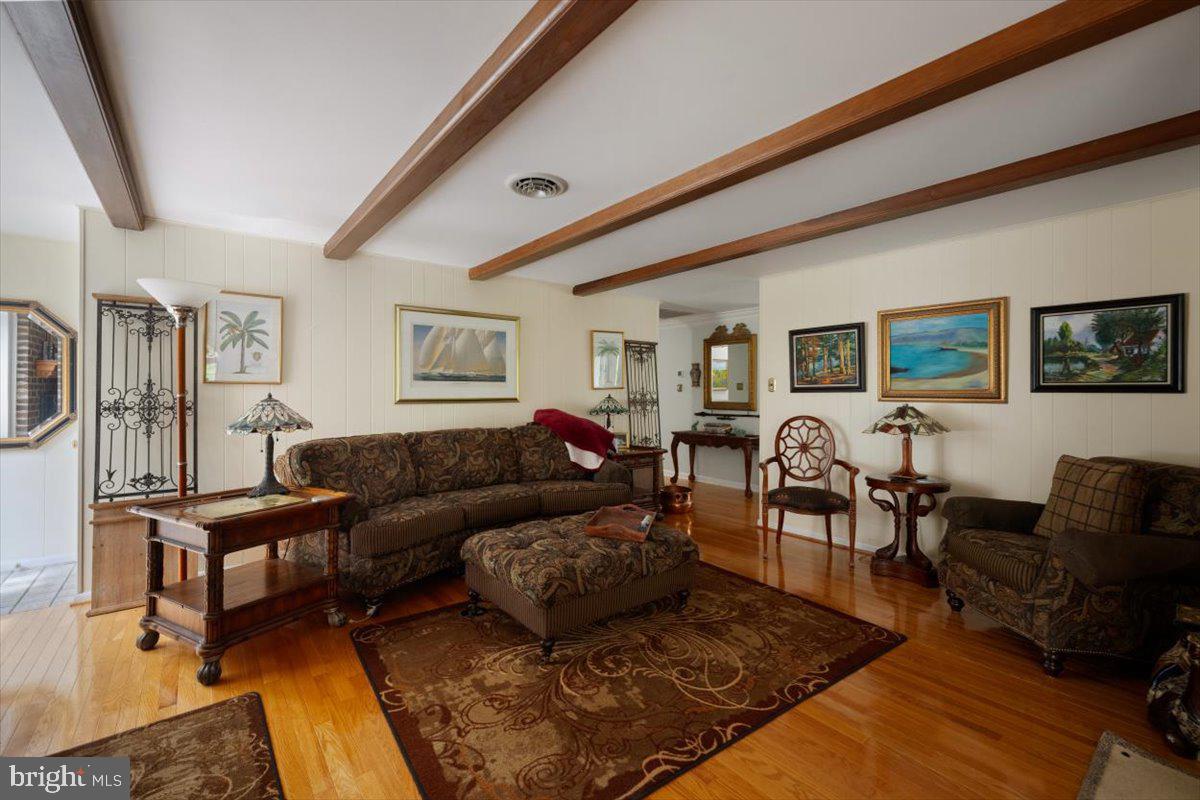 1049 Laurel Grove Road Winchester, VA 22602 - Photo 11 of 42 a living room with furniture wooden floor and wall paintings