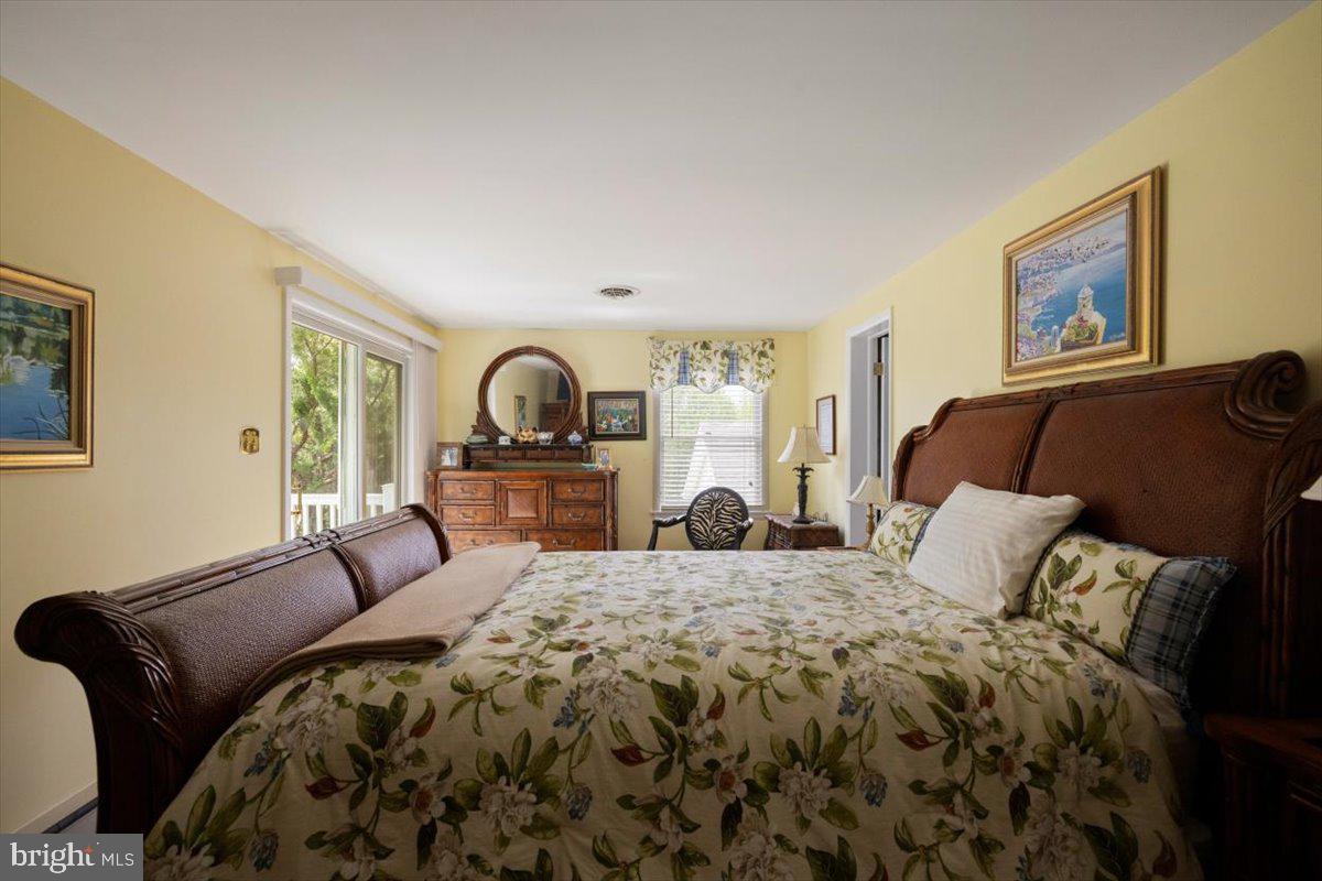 1049 Laurel Grove Road Winchester, VA 22602 - Photo 14 of 39 a bedroom with a bed and dresser with mirror